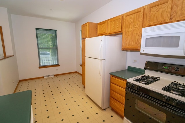 3404 Steeplechase Way, Grayslake, IL 60030 - kitchen with white appliances, light flooring, baseboards, and dark countertops