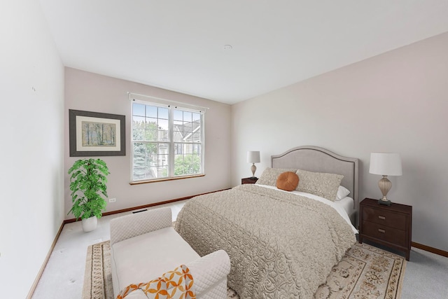 carpeted bedroom featuring baseboards