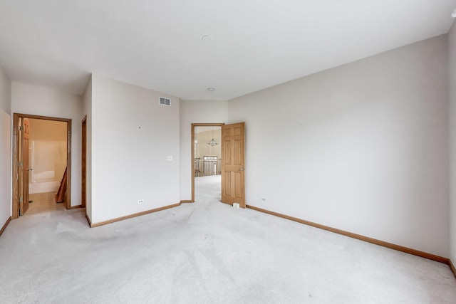 unfurnished bedroom with baseboards and light carpet