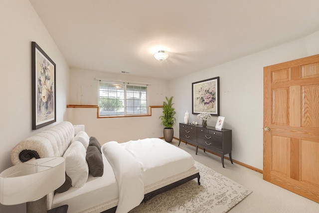 bedroom featuring carpet and baseboards