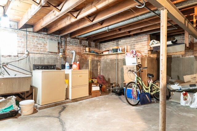 14535 University Ave, Dolton, IL 60419 - unfinished below grade area featuring washing machine and dryer, brick wall, and a sink