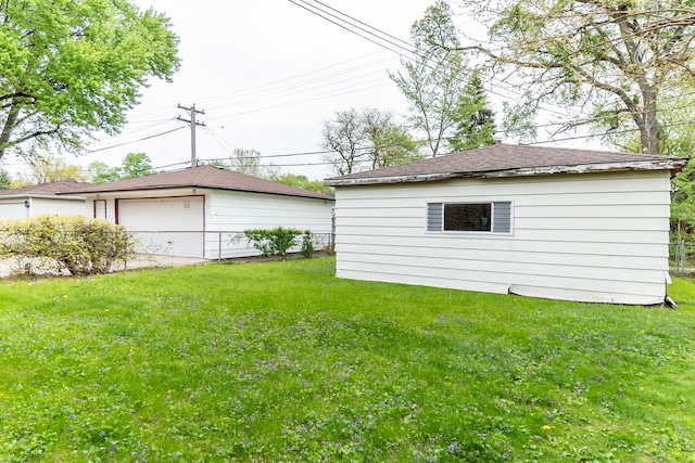 14535 University Ave, Dolton, IL 60419 - view of grassy yard featuring an outdoor structure and a detached garage