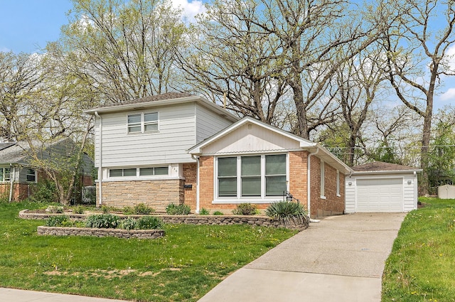 view of front of house featuring a detached garage, stone siding, driveway, an outbuilding, and a front yard