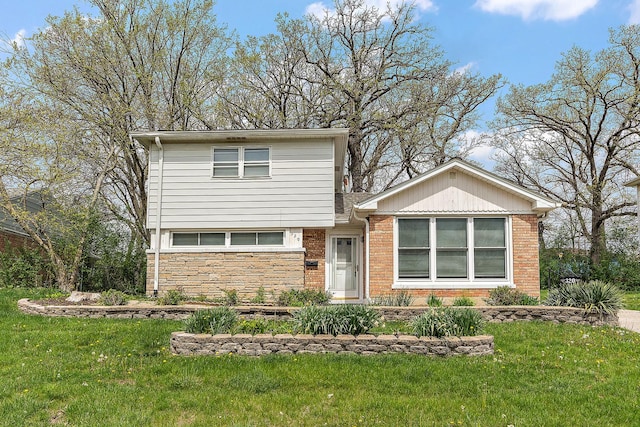 view of front facade with a front lawn, brick siding, and stone siding