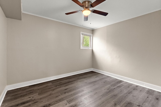 spare room featuring baseboards, ornamental molding, and wood finished floors