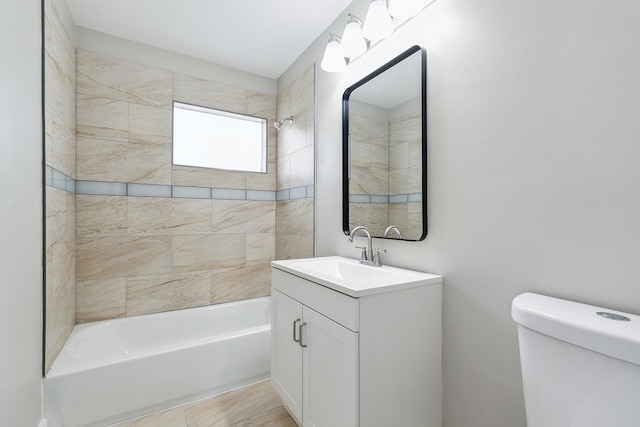 bathroom with toilet, tub / shower combination, and vanity