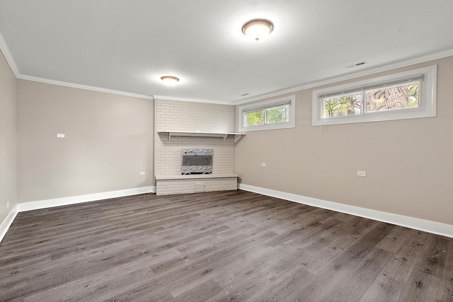 unfurnished living room with wood finished floors, a fireplace, and ornamental molding