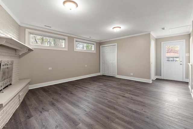 unfurnished living room with dark wood finished floors, visible vents, and ornamental molding