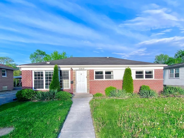 ranch-style house with brick siding and a front yard