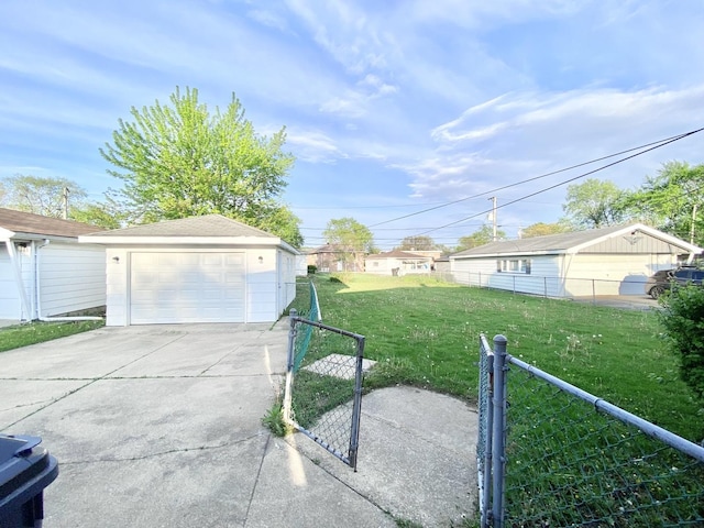 view of yard with a gate, a detached garage, fence, an outdoor structure, and concrete driveway