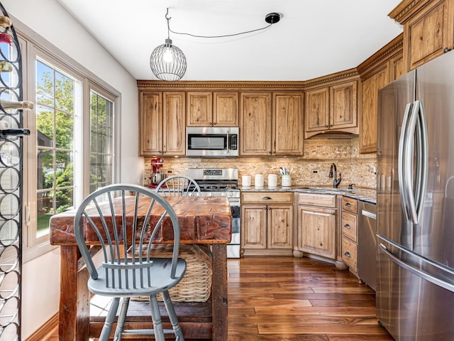 302 Delaware Dr, Bolingbrook, IL 60440 - kitchen featuring a sink, stainless steel appliances, dark wood finished floors, tasteful backsplash, and light stone counters