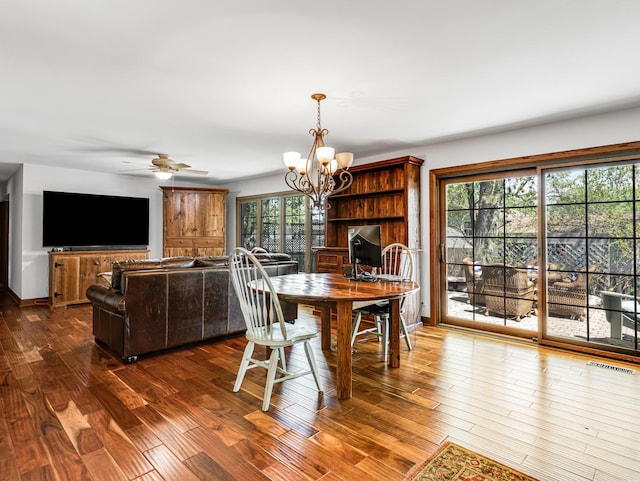 302 Delaware Dr, Bolingbrook, IL 60440 - dining space featuring dark wood-type flooring, ceiling fan with notable chandelier, and visible vents