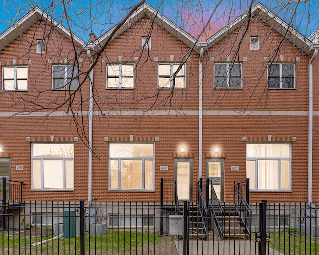 4879 N Winthrop Ave Unit D, Chicago, IL 60640 - view of front facade with a fenced front yard and brick siding