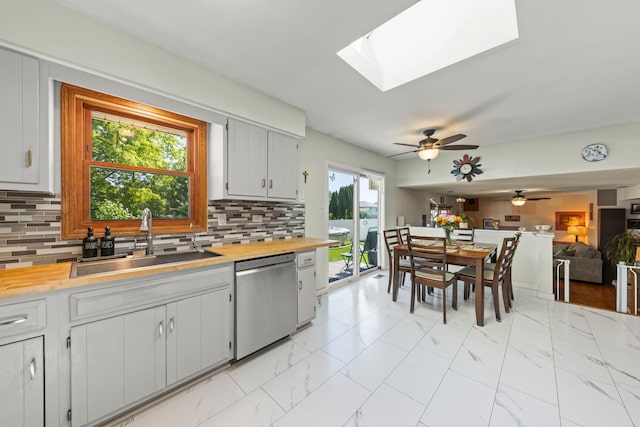 2810 Billie Limacher Ln, Plainfield, IL 60586 - kitchen with stainless steel dishwasher, a sink, tasteful backsplash, and light marble finish floors