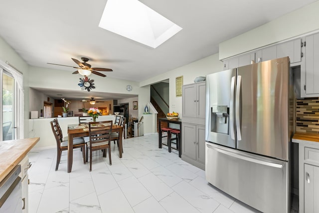 2810 Billie Limacher Ln, Plainfield, IL 60586 - dining area with ceiling fan, light marble finish flooring, a skylight, and stairway