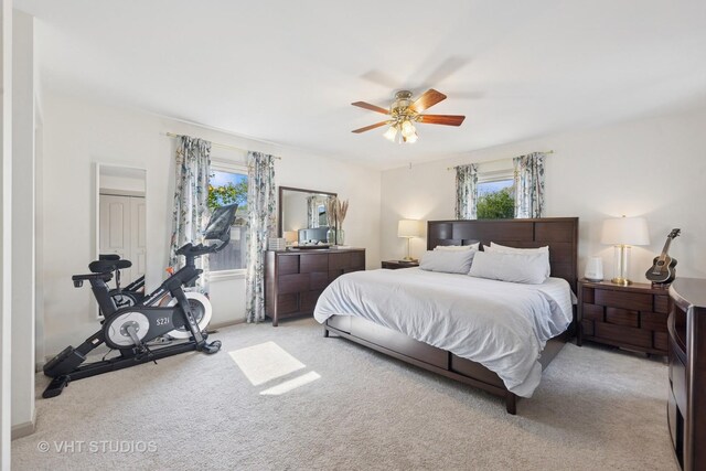 bedroom featuring multiple windows, carpet, and ceiling fan