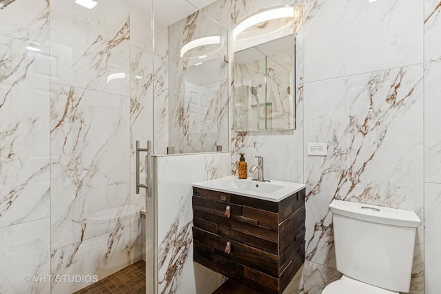 1450 Sandpebble Dr Unit 343, Wheeling, IL 60090 - bathroom featuring tile walls, a marble finish shower, toilet, and vanity