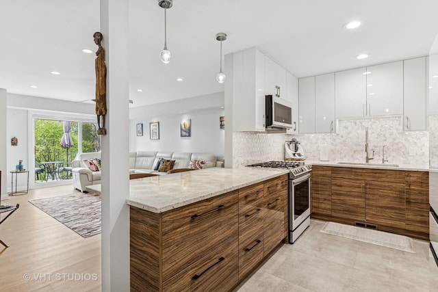 1450 Sandpebble Dr Unit 343, Wheeling, IL 60090 - kitchen featuring stainless steel gas range, a sink, modern cabinets, brown cabinets, and recessed lighting