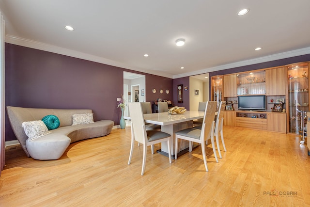 dining space with ornamental molding, light wood finished floors, and recessed lighting