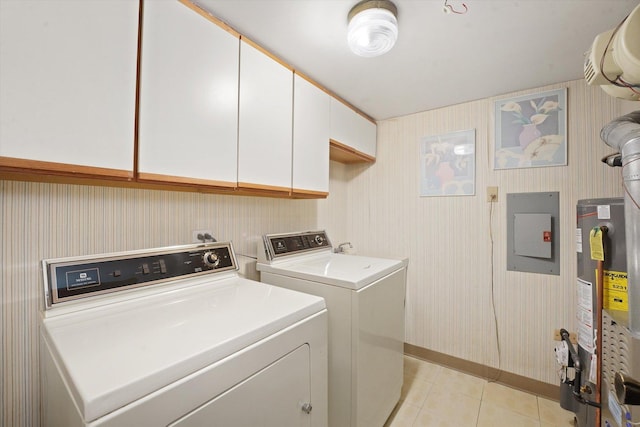 laundry area with washer and dryer, cabinet space, electric panel, gas water heater, and light tile patterned floors