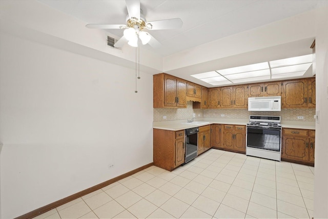 kitchen featuring gas stove, white microwave, dishwasher, brown cabinets, and a sink