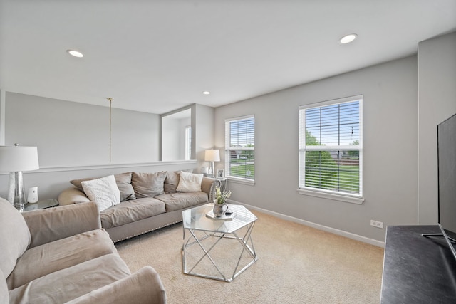 carpeted living area with baseboards and recessed lighting