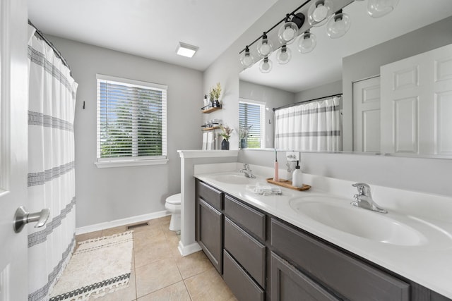 bathroom featuring toilet, visible vents, a sink, tile patterned flooring, and double vanity