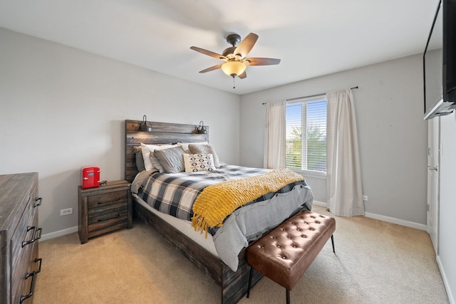 bedroom with baseboards, light carpet, and a ceiling fan