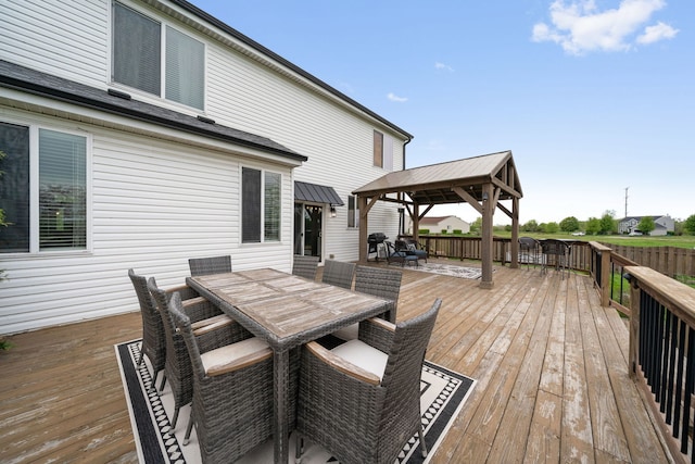 wooden deck featuring a gazebo and outdoor dining space