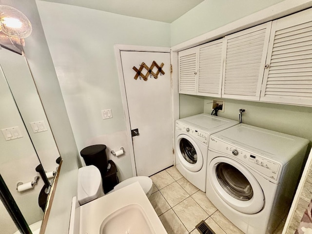14539 Avers Ave, Midlothian, IL 60445 - clothes washing area featuring separate washer and dryer, cabinet space, and light tile patterned floors