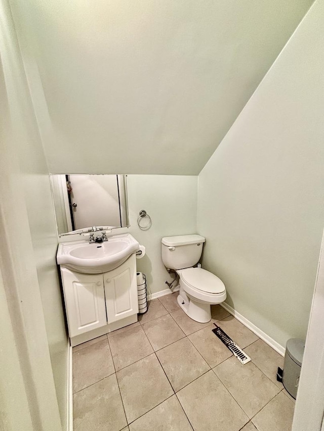14539 Avers Ave, Midlothian, IL 60445 - bathroom with toilet, tile patterned floors, vanity, lofted ceiling, and baseboards