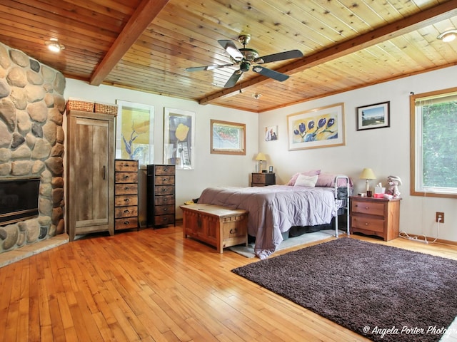 2912 Magellan Dr, Mchenry, IL 60051 - bedroom featuring a wood ceiling with exposed beams, light wood-style floors, a stone fireplace, and ceiling fan