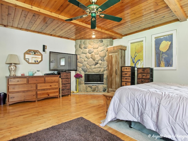 2912 Magellan Dr, Mchenry, IL 60051 - bedroom with a wooden ceiling with exposed beams, light wood-style floors, and a fireplace