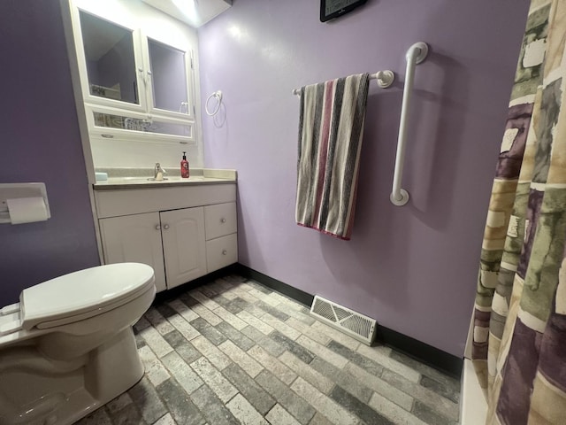 2912 Magellan Dr, Mchenry, IL 60051 - bathroom featuring vanity, toilet, brick patterned flooring, baseboards, and a shower with shower curtain