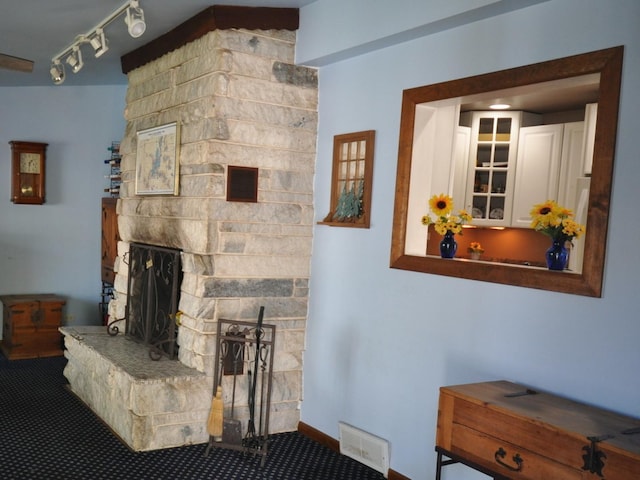 2912 Magellan Dr, Mchenry, IL 60051 - carpeted living area with a stone fireplace and rail lighting
