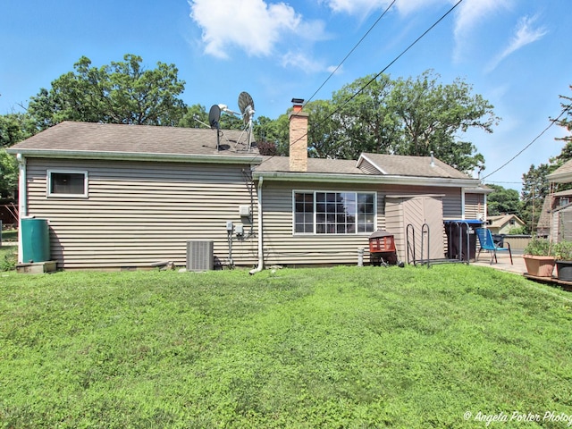 2912 Magellan Dr, Mchenry, IL 60051 - rear view of house with a chimney, a yard, and a shingled roof