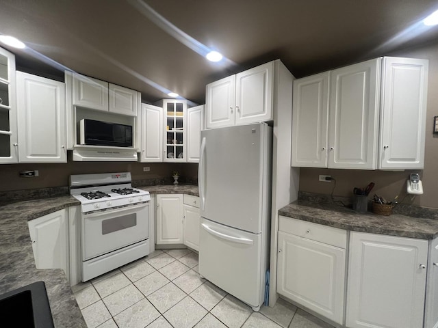 2912 Magellan Dr, Mchenry, IL 60051 - kitchen with white appliances, light tile patterned floors, and white cabinetry