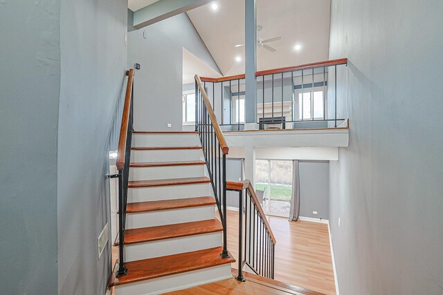 359 Juniper Tree Ct, Hoffman Estates, IL 60169 - stairs featuring baseboards, wood finished floors, a ceiling fan, and high vaulted ceiling