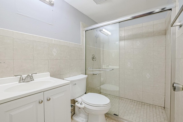 359 Juniper Tree Ct, Hoffman Estates, IL 60169 - bathroom with tile walls, toilet, a shower stall, tile patterned flooring, and vanity