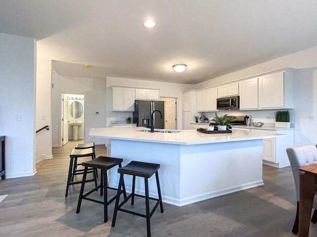 1587 Glenbrooke Ln, New Lenox, IL 60451 - kitchen with stainless steel microwave, a sink, white cabinetry, and a large island