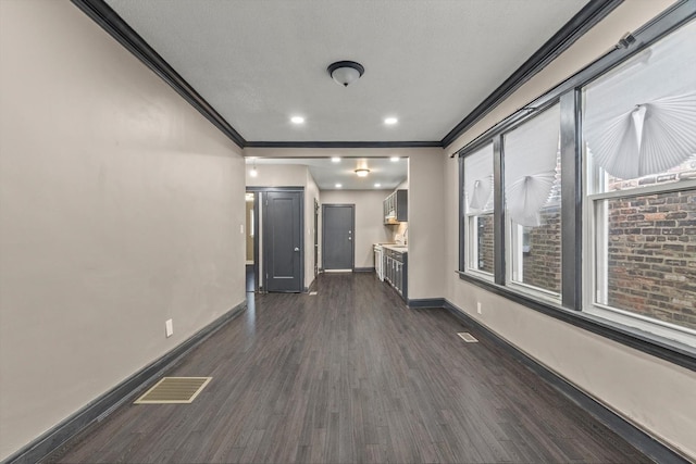 8943 S Lowe Ave, Chicago, IL 60620 - unfurnished living room featuring baseboards, ornamental molding, dark wood finished floors, and visible vents