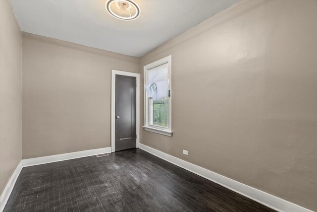8943 S Lowe Ave, Chicago, IL 60620 - unfurnished room with baseboards, visible vents, and dark wood-type flooring