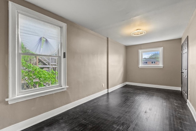 8943 S Lowe Ave, Chicago, IL 60620 - empty room with baseboards and dark wood-style flooring