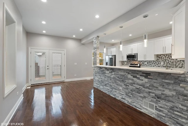 4631 S Evans Ave, Chicago, IL 60653 - kitchen featuring appliances with stainless steel finishes, white cabinetry, dark wood-type flooring, light countertops, and recessed lighting
