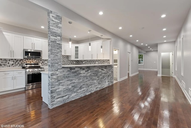 4631 S Evans Ave, Chicago, IL 60653 - kitchen with stainless steel appliances, tasteful backsplash, white cabinets, dark wood-style flooring, and recessed lighting