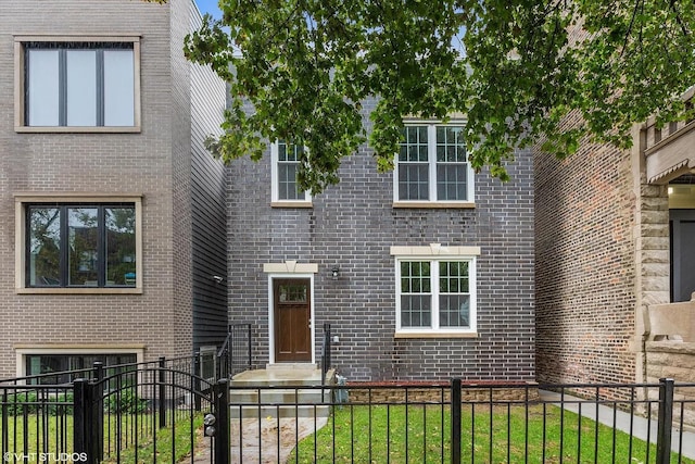 4631 S Evans Ave, Chicago, IL 60653 - view of front of house featuring a fenced front yard and brick siding