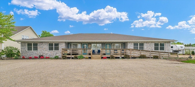 rear view of property with brick siding