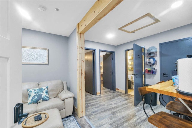 interior space with light wood-style flooring and attic access