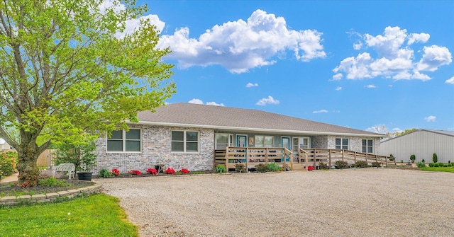 single story home featuring brick siding
