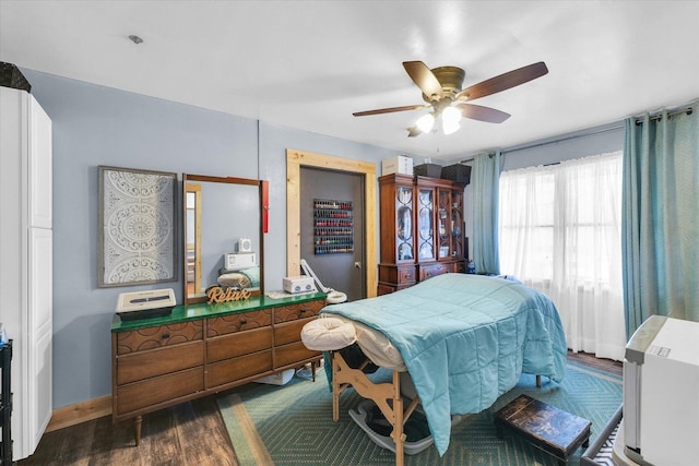 bedroom with wood finished floors, baseboards, and ceiling fan